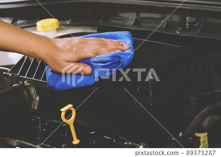 Car mechanic using blue microfiber cloth cleaning engine car Car mechanic using blue microfiber cloth cleaning engine car 89373287