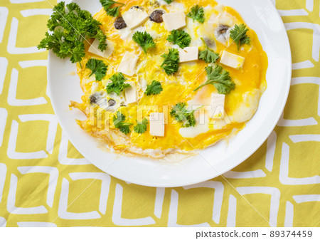 Scrambled eggs with fresh herbs on a plate 89374459