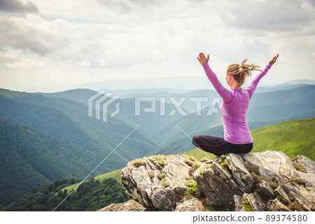 Young woman on the top of mountain 89374580