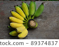 Ripe banana fruit green and yellow color from organic farm with nature light, put on wooden table background 89374837
