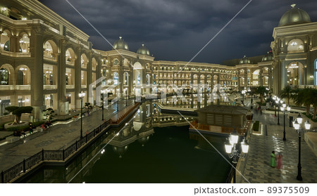 Place Vendome Mall  in Lusail city, Qatar interior view at night showing the architecture of the mall with big fountain in foreground  89375509