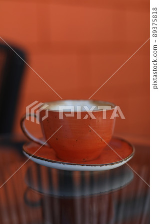 a cup of coffee on glass table in the morning  89375818