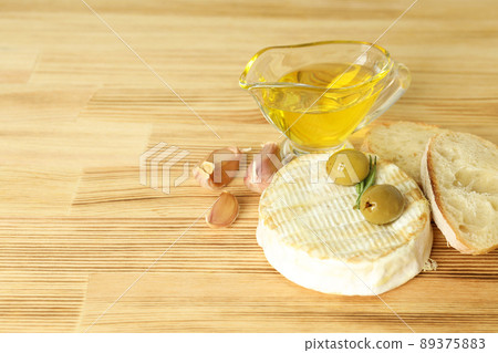 Concept of tasty food with grilled camembert on wooden background Concept of tasty food with grilled camembert on wooden background 89375883