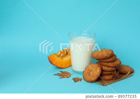 Milk and pumpkin cookies on blue background 89377235