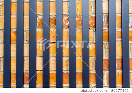 Iron sticks on a brick wall texture background. 89377361