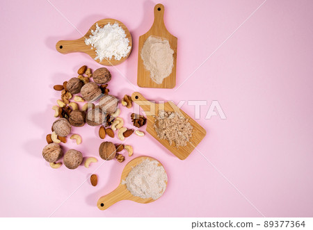 Alternative nut flour. Various keto paleo gluten, grain free. Almond, walnut, cashew flour. Copy space. Pink background 89377364