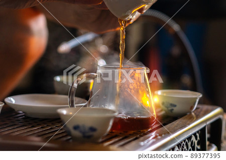 Tea ceremony, pours tea close-up, selective focus, brewing Chinese tea the original method. 89377395