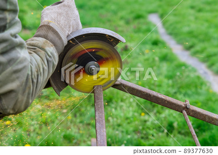 Metal processing with angle grinder sparks in metalworking works Metal processing with angle grinder sparks in metalworking works 89377630
