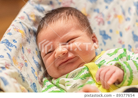 portrait of a smiling infant baby in his bed portrait of a smiling infant baby in his bed 89377654