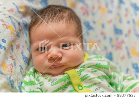 Portrait of Infant baby lying in his bed Portrait of Infant baby lying in his bed 89377655