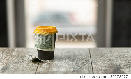 Generous tip left behind a cup of coffee Generous tip left behind a cup of coffee 89378977