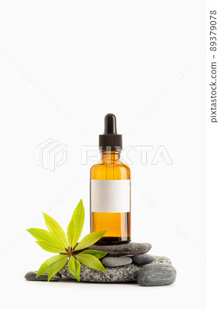 Herbal Essential oil on amber bottle with blank label isolated on white background. Template Mock up. Copy space Herbal Essential oil on amber bottle with blank label isolated on white background. Template Mock up. Copy space 89379078