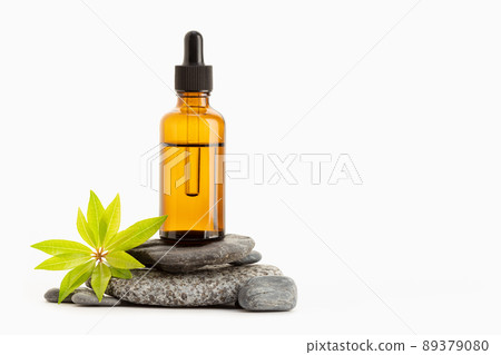 Herbal Essential oil on amber bottle isolated on white background. Copy space Herbal Essential oil on amber bottle isolated on white background. Copy space 89379080