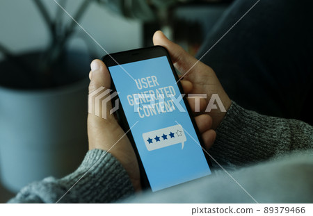 man and cellphone with text user generated content 89379466