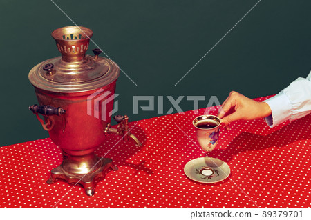Colorful bright image of old-fashioned kettle called samovar isolated over dark green background. Colorful bright image of old-fashioned kettle called samovar isolated over dark green background. 89379701