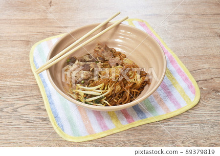 dry Chinese yellow egg noodles dressing black soy sauce topping braised pork on bowl dry Chinese yellow egg noodles dressing black soy sauce topping braised pork on bowl 89379819