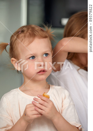 Cute smiling little girl with sushi on white background. Child girl eating sushi and rolls - commercial concept. Cute smiling little girl with sushi on white background. Child girl eating sushi and rolls - commercial concept. 89379822