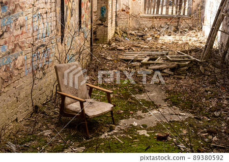 Abandoned house. Moss grows inside. Everything is broken and destroyed. An old armchair in the center of the room Abandoned house. Moss grows inside. Everything is broken and destroyed. An old armchair in the center of the room 89380592