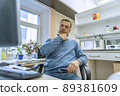 Male scientist thinking at his computer during research in laboratory. Serious male with computer in biochemistry office. Millennial man working on computer in laboratory 89381609