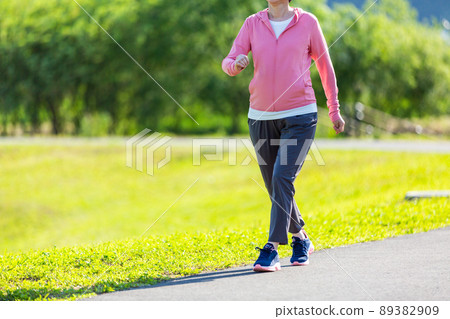 Japanese middle-aged woman exercising in an outdoor park 89382909