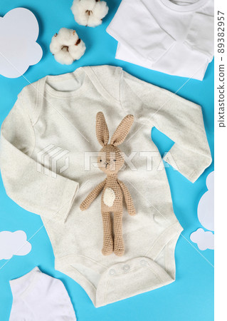Concept of cute baby clothes on blue background 89382957