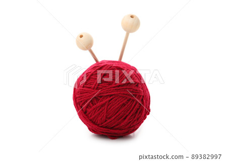 Red yarn ball with knitting needles, isolated on white background Red yarn ball with knitting needles, isolated on white background 89382997