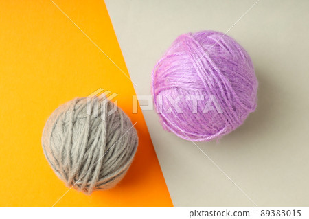 Multi colored balls of yarn on two tone background Multi colored balls of yarn on two tone background 89383015