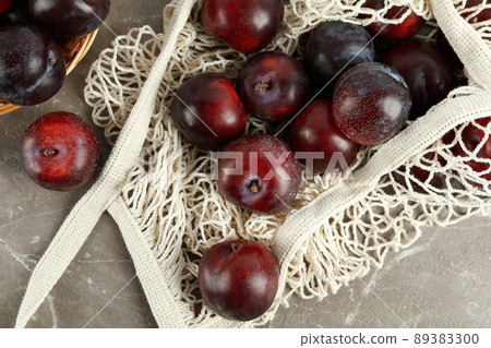 Concept of fruits with plums on gray textured table Concept of fruits with plums on gray textured table 89383300