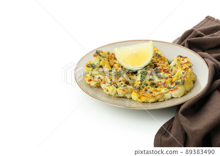 Plate with baked cauliflower and kitchen towel isolated on white background Plate with baked cauliflower and kitchen towel isolated on white background 89383490