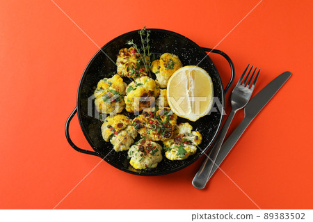 Concept of tasty food with baked cauliflower on orange background 89383502