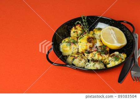 Concept of tasty food with baked cauliflower on orange background Concept of tasty food with baked cauliflower on orange background 89383504