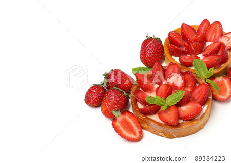 Delicious strawberry tarts isolated on white background Delicious strawberry tarts isolated on white background 89384223
