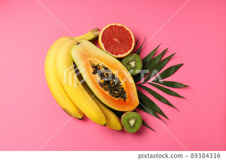 Fresh and ripe exotic fruits on pink background 89384316