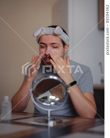 Men's beauty concept. caucAsian guy checking his skin. Men's beauty concept. caucAsian guy checking his skin. 89384362