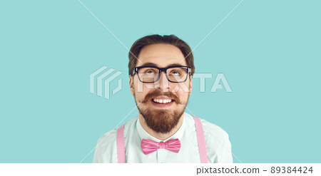 Funny bearded man in glasses look up thinking Funny bearded man in glasses look up thinking 89384424
