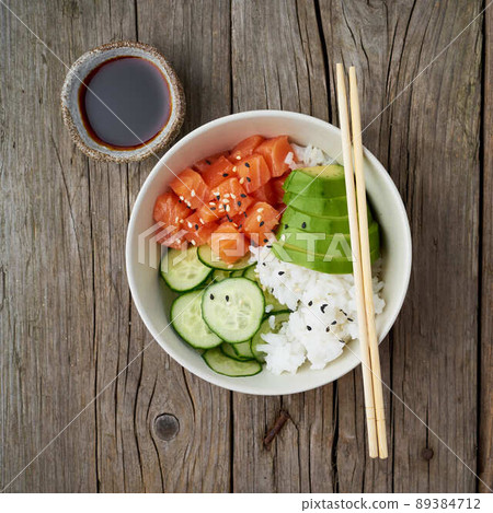 salmon poke bowl with fresh fish, rice, cucumber, avocado salmon poke bowl with fresh fish, rice, cucumber, avocado 89384712