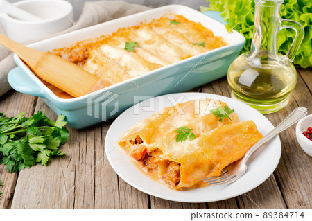 Cannelloni with filling of ground beef, tomatoes, 89384714