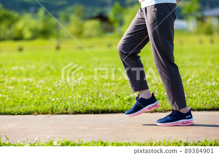 The feet of a middle-aged woman walking outdoors The feet of a middle-aged woman walking outdoors 89384901