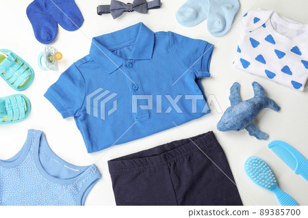 Concept of cute baby clothes on white background Concept of cute baby clothes on white background 89385700