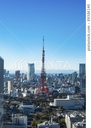 Tokyo Tower surrounded by dense buildings, Tokyo Tower shining in the blue sky seen from the observatory 89386140