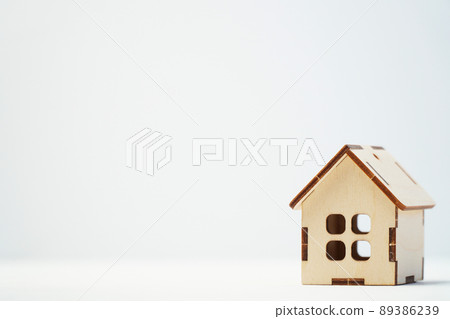 Wooden house model on white background with copy space Wooden house model on white background with copy space 89386239