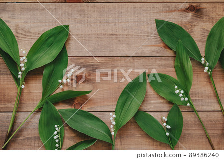 Lilies of the valley on natural wooden backgrond. Flower card. Lilies of the valley on natural wooden backgrond. Flower card. 89386240