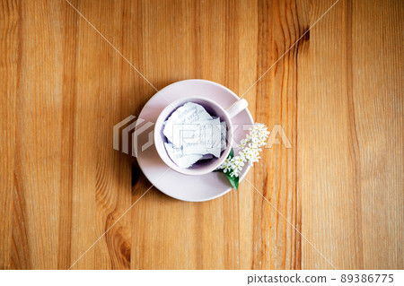 Affirmation, inspirational quotes concept. Paper with motivation message and inspirational quotes in pink tea cap on wooden table Affirmation, inspirational quotes concept. Paper with motivation message and inspirational quotes in pink tea cap on wooden table 89386775