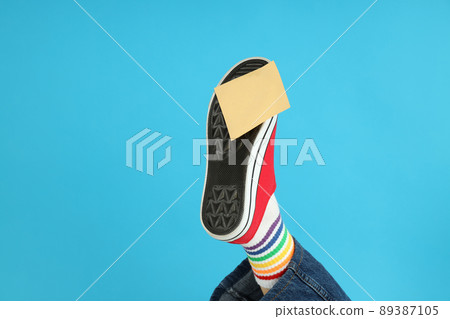 Blank sticker pasted on red sneaker on blue background Blank sticker pasted on red sneaker on blue background 89387105
