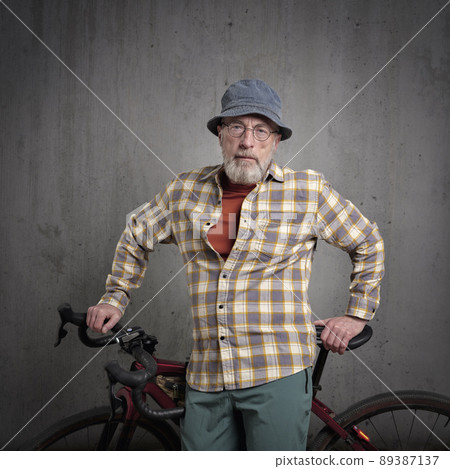 senior cyclist iwith a gravel or touring bike 89387137