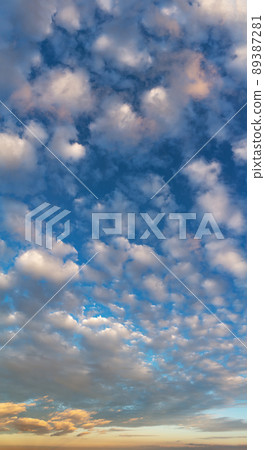 Fantastic clouds at sunrise, vertical panorama 89387281