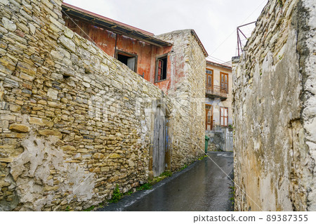 view of a romantic narrow street in a small, partially uninhabited mountain village in Cyprus view of a romantic narrow street in a small, partially uninhabited mountain village in Cyprus 89387355