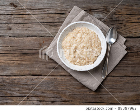 Large bowl of tasty and healthy oatmeal for Breakfast, morning meal. Top view, close up, wooden rustic table Large bowl of tasty and healthy oatmeal for Breakfast, morning meal. Top view, close up, wooden rustic table 89387962