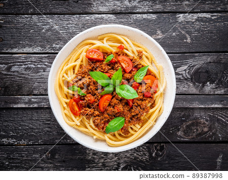 pasta bolognese with tomato sauce, ground minced beef, basil leaves on background pasta bolognese with tomato sauce, ground minced beef, basil leaves on background 89387998