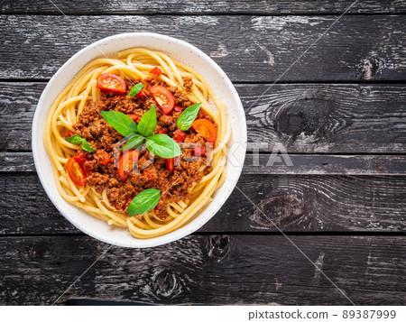 pasta bolognese with tomato sauce, ground minced beef, basil leaves on background pasta bolognese with tomato sauce, ground minced beef, basil leaves on background 89387999